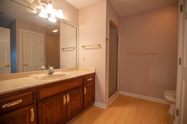 2132 Neelys Bend Rd, Madison, TN 37115 - bathroom featuring vanity, wood finished floors, toilet, a shower stall, and baseboards