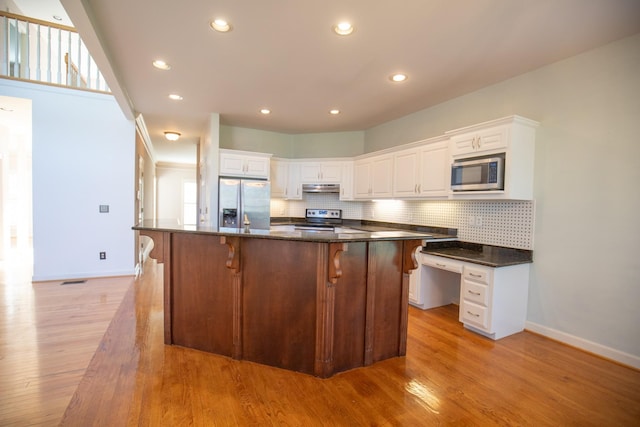 2132 Neelys Bend Rd, Madison, TN 37115 - kitchen featuring appliances with stainless steel finishes, under cabinet range hood, baseboards, backsplash, and recessed lighting