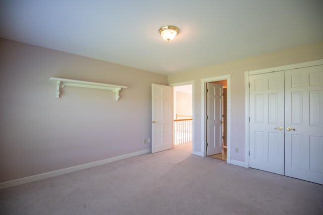 2132 Neelys Bend Rd, Madison, TN 37115 - unfurnished bedroom with baseboards, carpet floors, and a closet