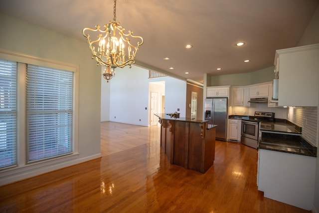 2132 Neelys Bend Rd, Madison, TN 37115 - kitchen with stainless steel appliances, under cabinet range hood, dark countertops, white cabinetry, and recessed lighting