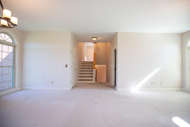 2132 Neelys Bend Rd, Madison, TN 37115 - spare room featuring light colored carpet, healthy amount of natural light, stairs, and baseboards