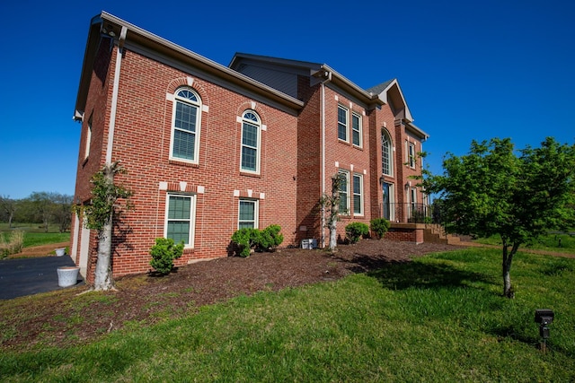 2132 Neelys Bend Rd, Madison, TN 37115 - view of front of home featuring a front yard, brick siding, and an attached garage