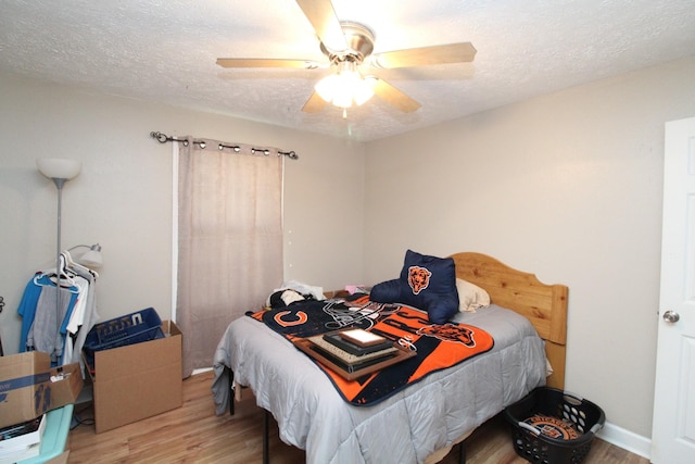 320 Benson Rd, Reagan, TN 38368 - bedroom featuring a textured ceiling, wood finished floors, and ceiling fan