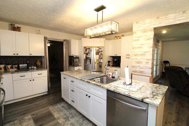 320 Benson Rd, Reagan, TN 38368 - kitchen featuring dark wood-style flooring, white cabinetry, a textured ceiling, stainless steel appliances, and hanging light fixtures