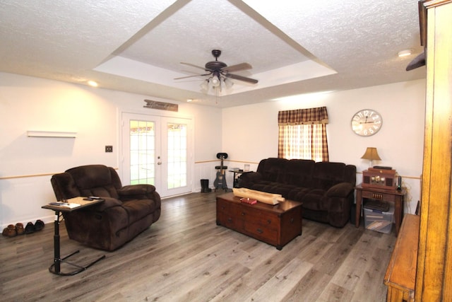 320 Benson Rd, Reagan, TN 38368 - living room featuring a textured ceiling, a tray ceiling, a ceiling fan, and wood finished floors