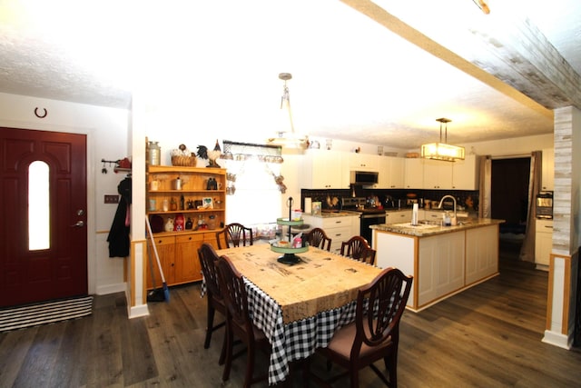 320 Benson Rd, Reagan, TN 38368 - dining area with dark wood-type flooring and a textured ceiling