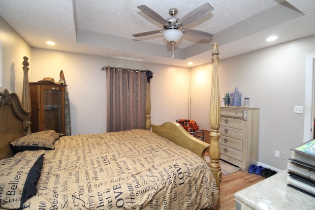320 Benson Rd, Reagan, TN 38368 - bedroom with a tray ceiling, recessed lighting, wood finished floors, and a textured ceiling