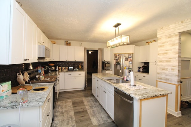 320 Benson Rd, Reagan, TN 38368 - kitchen with an island with sink, backsplash, stainless steel appliances, a sink, and wood finished floors