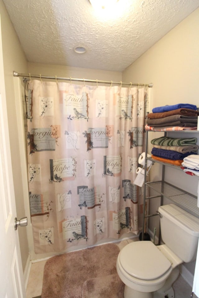 320 Benson Rd, Reagan, TN 38368 - full bathroom featuring toilet, a shower with shower curtain, and a textured ceiling