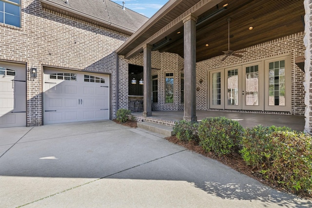 61 Harbor Cove Dr, Old Hickory, TN 37138 - view of exterior entry featuring ceiling fan, brick siding, french doors, driveway, and roof with shingles