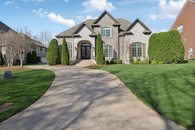 61 Harbor Cove Dr, Old Hickory, TN 37138 - french country style house featuring stone siding, a front lawn, brick siding, french doors, and driveway