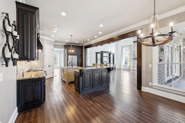 61 Harbor Cove Dr, Old Hickory, TN 37138 - kitchen featuring dark wood-style flooring, a large island, a chandelier, crown molding, and visible vents