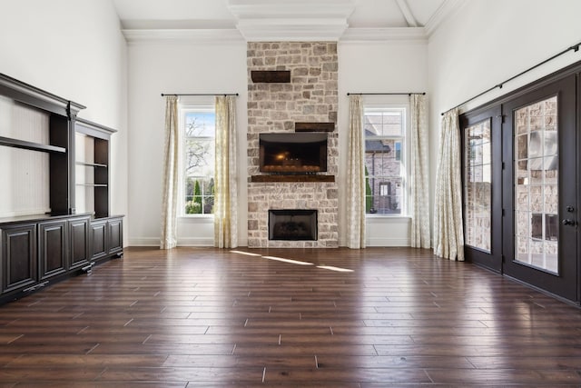 61 Harbor Cove Dr, Old Hickory, TN 37138 - unfurnished living room with baseboards, dark wood-type flooring, a stone fireplace, and crown molding