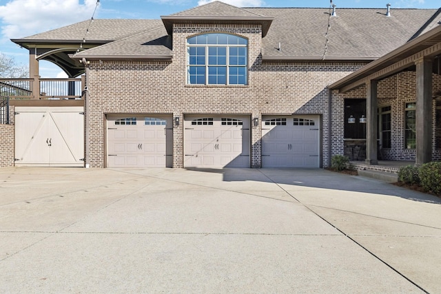 61 Harbor Cove Dr, Old Hickory, TN 37138 - view of side of home with brick siding, a shingled roof, a garage, and concrete driveway
