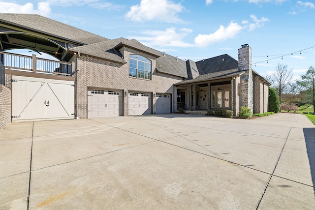 61 Harbor Cove Dr, Old Hickory, TN 37138 - view of front of property featuring brick siding, a garage, driveway, and a chimney