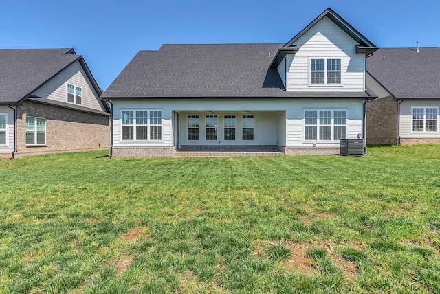 back of house with brick siding, central air condition unit, a lawn, and ceiling fan