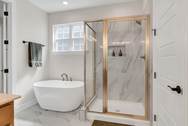 full bath with a marble finish shower, marble finish floor, a freestanding tub, and vanity