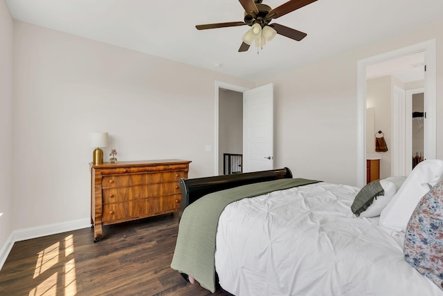 bedroom featuring ceiling fan, dark wood-style flooring, and baseboards
