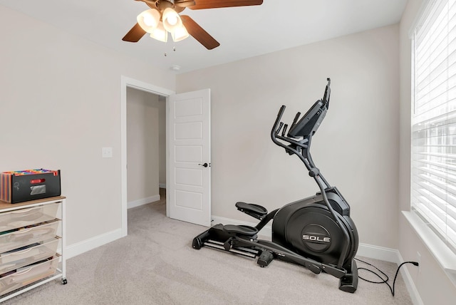 exercise room with carpet flooring, baseboards, and a ceiling fan