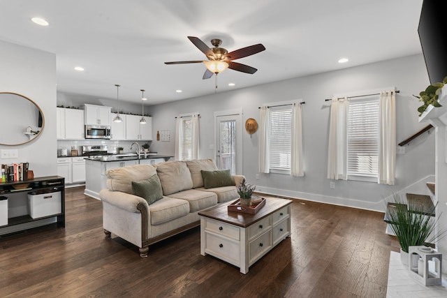 living room with baseboards, ceiling fan, recessed lighting, stairs, and dark wood-type flooring