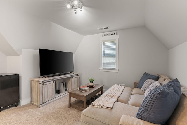 living area with light carpet, visible vents, and lofted ceiling