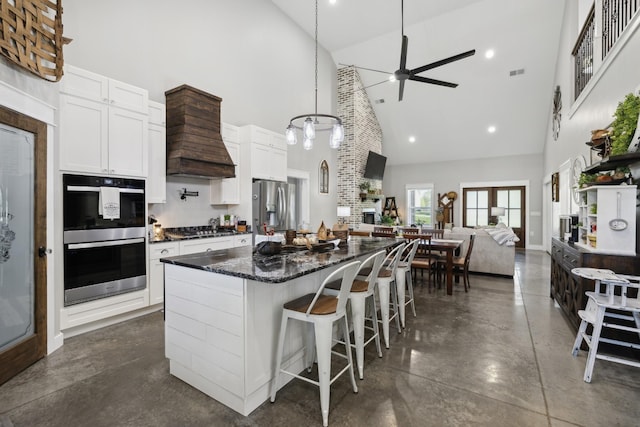 208 Lakeview Dr, Hohenwald, TN 38462 - kitchen featuring high vaulted ceiling, appliances with stainless steel finishes, ceiling fan, open floor plan, and a center island
