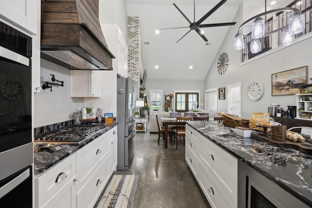 208 Lakeview Dr, Hohenwald, TN 38462 - kitchen with custom exhaust hood, finished concrete flooring, a ceiling fan, high vaulted ceiling, and appliances with stainless steel finishes