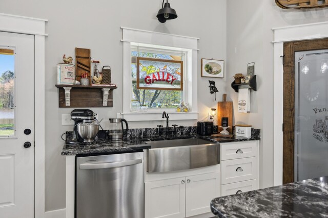 208 Lakeview Dr, Hohenwald, TN 38462 - kitchen with stainless steel dishwasher, a sink, white cabinets, dark stone counters, and healthy amount of natural light