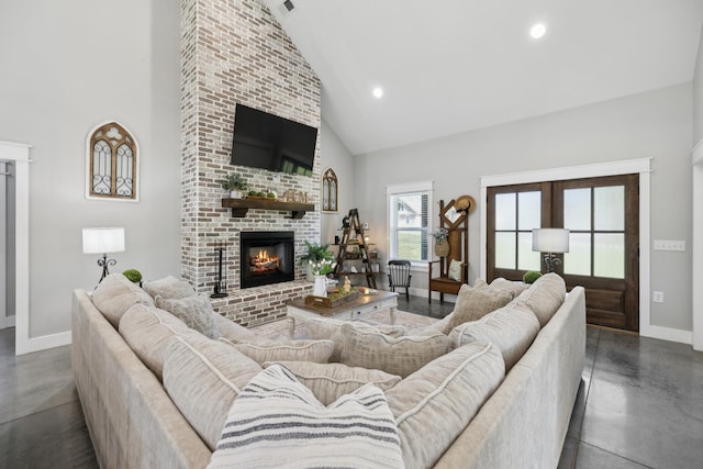 208 Lakeview Dr, Hohenwald, TN 38462 - living area featuring high vaulted ceiling, baseboards, a fireplace, concrete floors, and recessed lighting