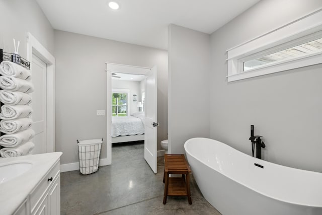 208 Lakeview Dr, Hohenwald, TN 38462 - ensuite bathroom featuring finished concrete floors, a freestanding bath, vanity, baseboards, and recessed lighting