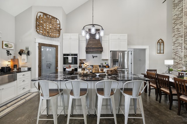 208 Lakeview Dr, Hohenwald, TN 38462 - kitchen featuring appliances with stainless steel finishes, high vaulted ceiling, finished concrete floors, white cabinetry, and a center island