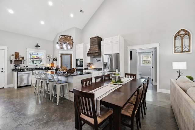 208 Lakeview Dr, Hohenwald, TN 38462 - dining area featuring high vaulted ceiling, finished concrete floors, baseboards, a chandelier, and recessed lighting