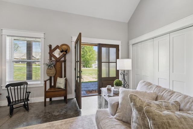208 Lakeview Dr, Hohenwald, TN 38462 - living room with healthy amount of natural light, concrete floors, baseboards, and high vaulted ceiling