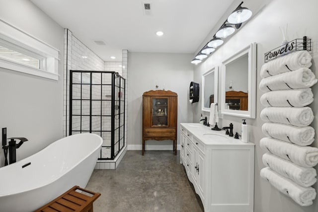 208 Lakeview Dr, Hohenwald, TN 38462 - full bath with concrete floors, a soaking tub, a stall shower, double vanity, and recessed lighting
