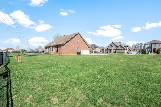view of yard featuring a trampoline and fence