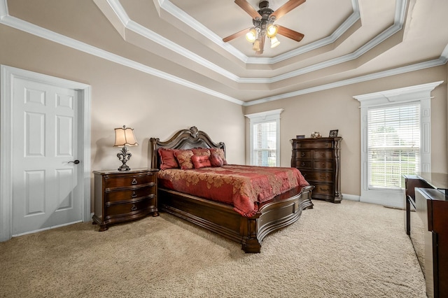 bedroom featuring ornamental molding, a raised ceiling, carpet, and a ceiling fan
