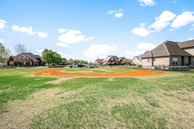 view of yard featuring a residential view and fence