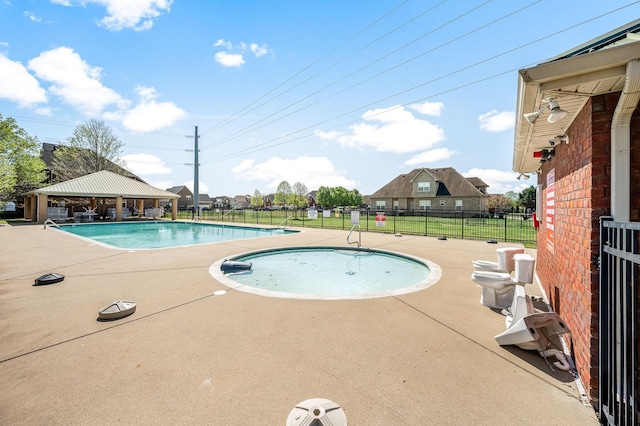 pool with a gazebo, a patio area, and fence