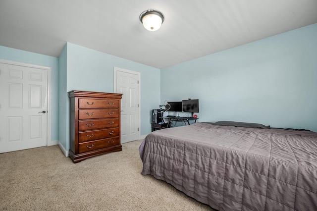 bedroom with light carpet and baseboards