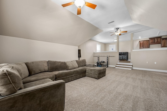 living area with baseboards, carpet flooring, a ceiling fan, visible vents, and lofted ceiling