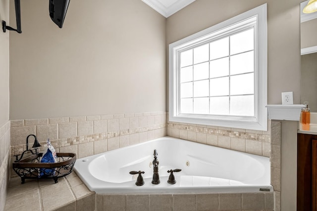 bathroom featuring vanity, crown molding, and a tub with jets