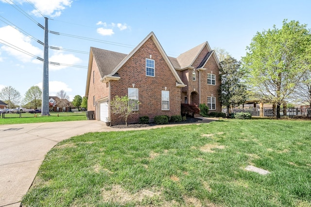 traditional home with brick siding, a front lawn, fence, and driveway