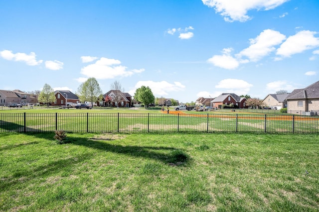 view of yard featuring fence and a residential view