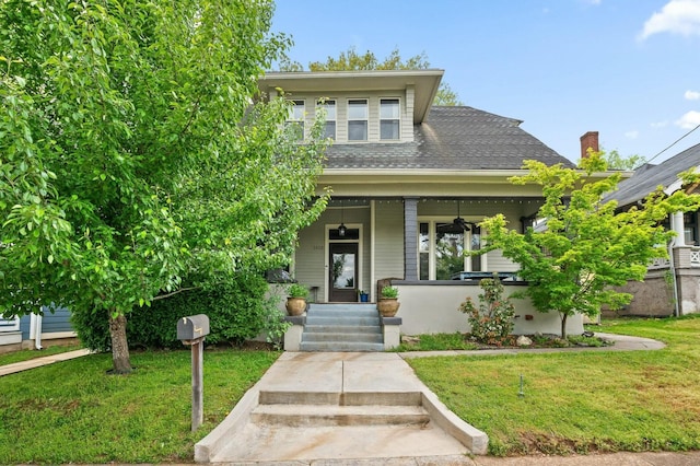 view of front of house with covered porch and a front yard