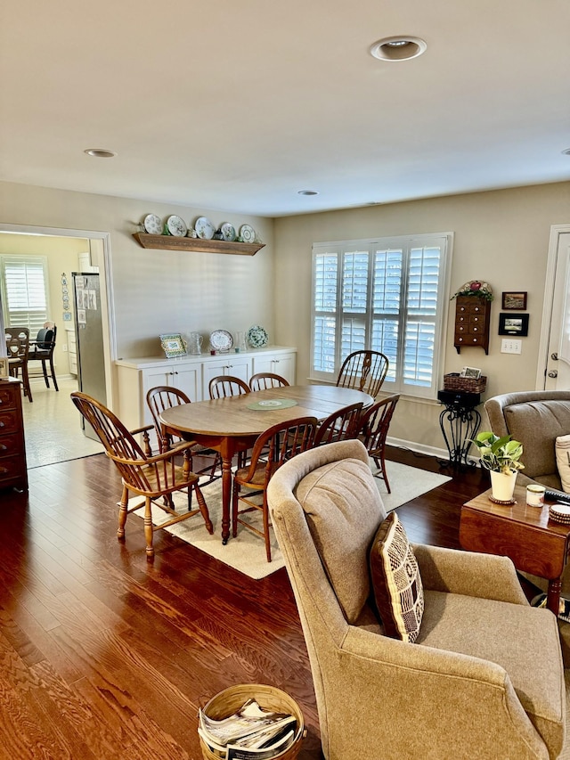 dining space featuring a wealth of natural light, baseboards, and wood finished floors