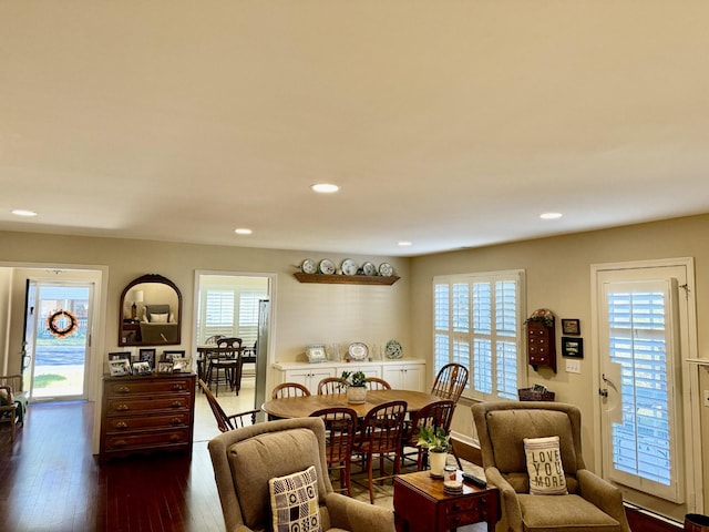 living area with dark wood-style floors, plenty of natural light, and recessed lighting