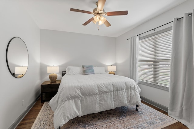 bedroom featuring dark wood-style flooring, baseboards, and a ceiling fan