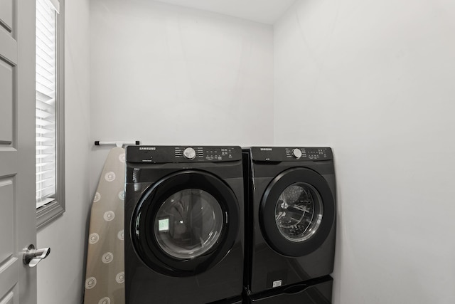 laundry area with washer and clothes dryer and laundry area