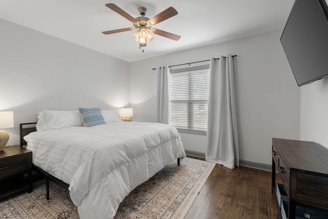 bedroom featuring baseboards, a ceiling fan, and wood finished floors