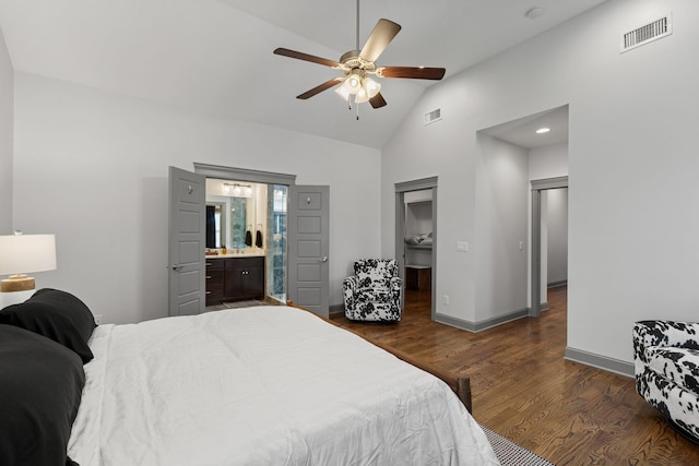 bedroom with a spacious closet, high vaulted ceiling, dark wood finished floors, and visible vents
